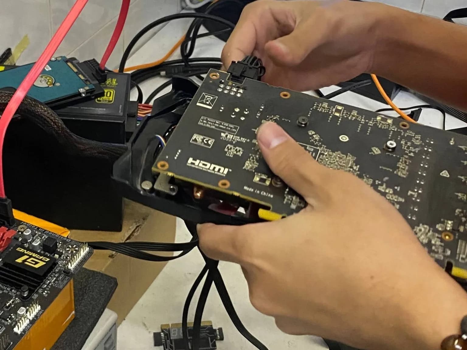 Technician replacing a DisplayPort connector on a graphic card